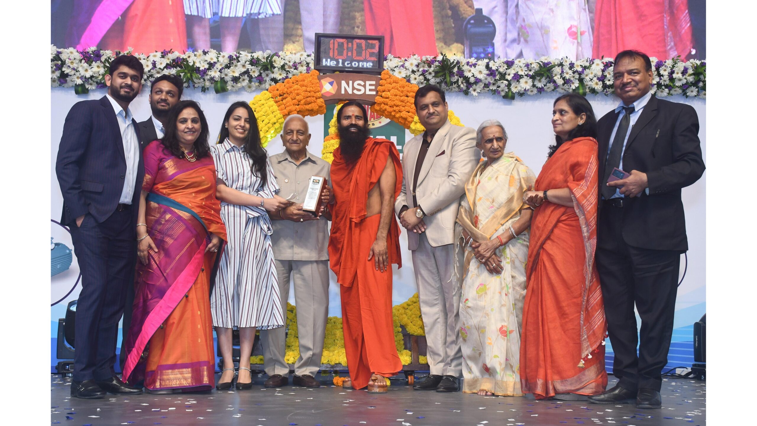 Shri. Baba Ramdev and Vivek Gupta CMD of Oswal Pumps Limited along with Gupta family at the prestigious Listing ceremony NSE 1 scaled